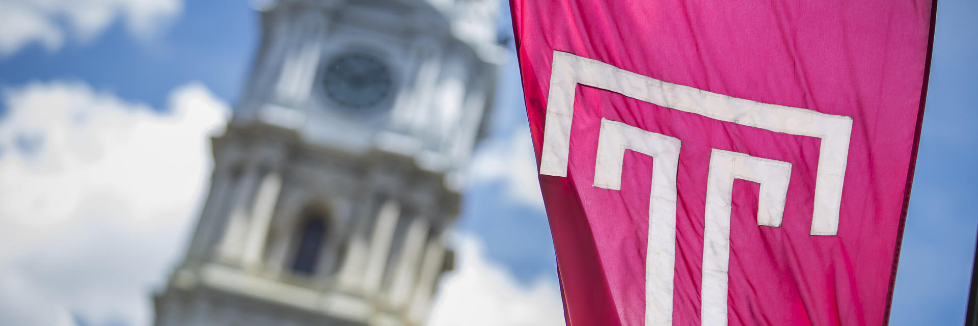 Temple banner waves in front of City Hall